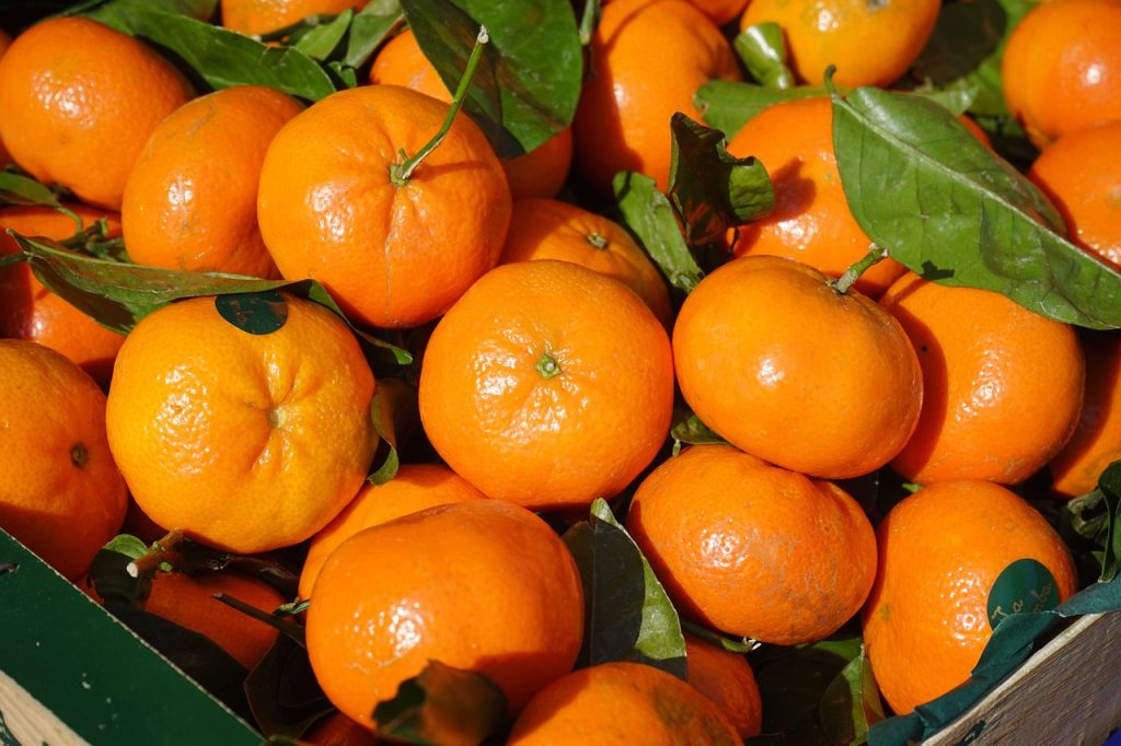clementines in a black cardboard tray